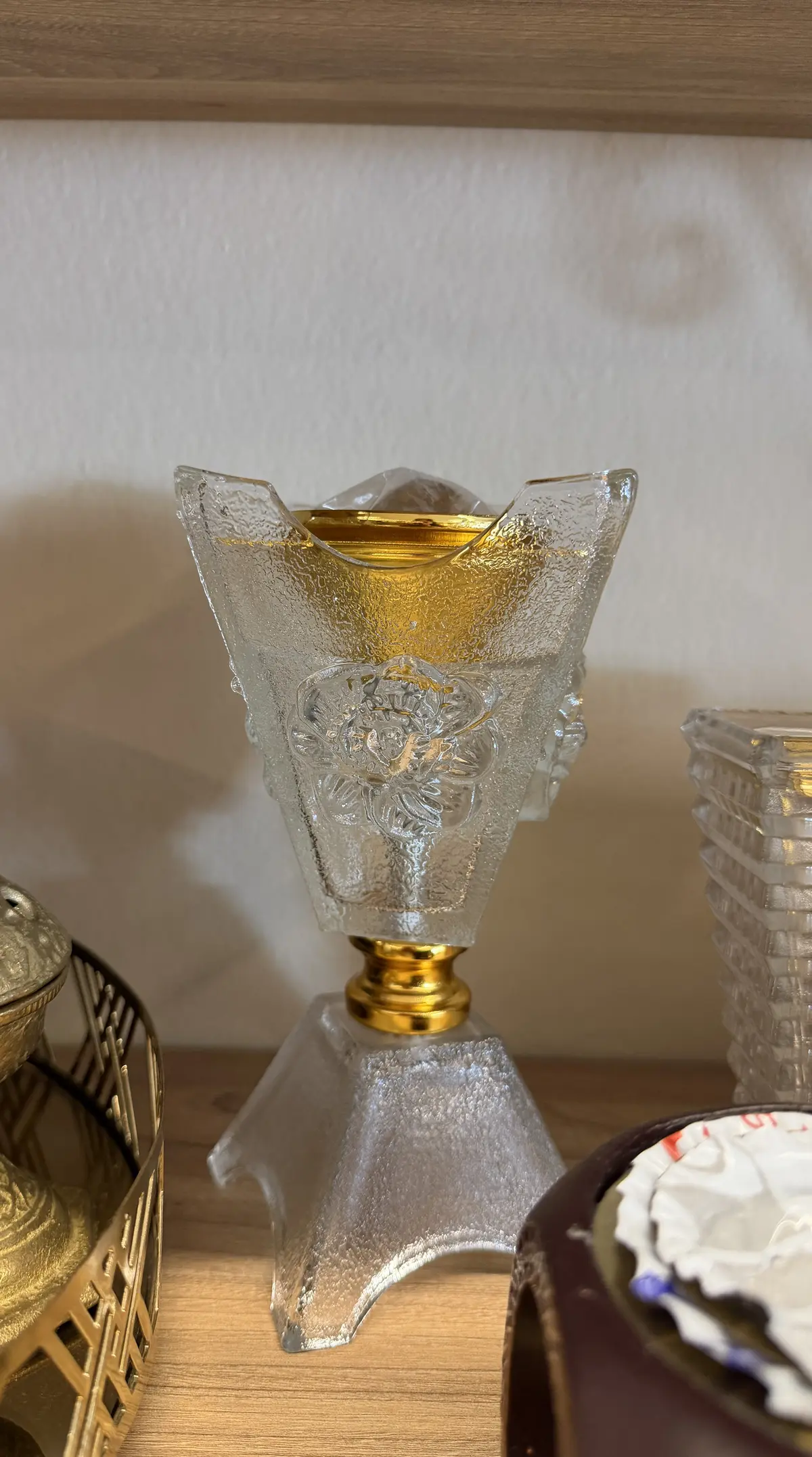 A crystal and gold incense burner on a shelf inside House of Khayal